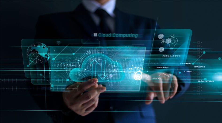 Man holds futuristic device that shows a cloud and the phrase "cloud computing" is illuminated.