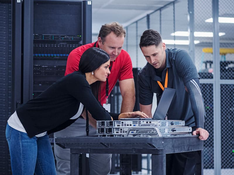 data center team looking at laptop